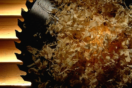 Circular circular saw lies on a glowing dark wooden backgroundの写真素材