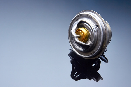 thermostat for engine cooling system of the car is wet to a dark glass