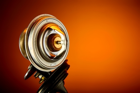 thermostat for engine cooling system of the car is wet to a dark glassの写真素材