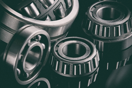 Close-up of a set of ball and roller bearings on a dark backgroundの写真素材