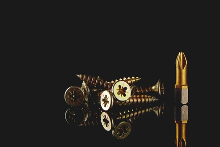 Screwdriver head, close-up bit, selective focus. blurred dark backgroundの写真素材