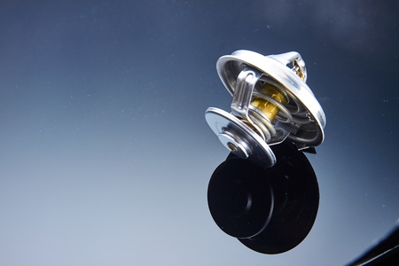 thermostat for engine cooling system of the car is wet to a dark glass