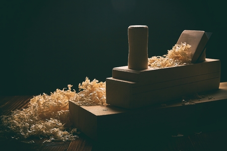 Shaving plane wooden shavings hammer flat chisels construction concept.
