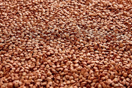 Textured background of natural buckwheat spread out on the table