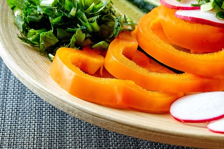 Spring vegetable salad with pepper, radish, onion, parsley and cucumbers.の写真素材