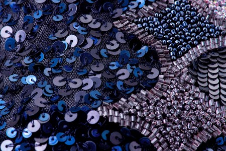 Fabric with sequins and sequins of bright colors. Fashion glitter fabric, sequins. can be used as backgroundの写真素材