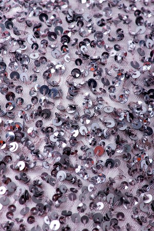 Fabric with sequins and sequins of bright colors. Fashion glitter fabric, sequins. can be used as backgroundの写真素材