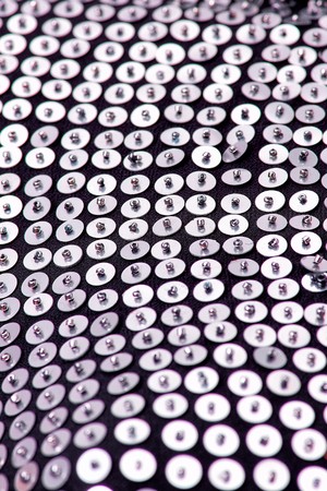 Fabric with sequins and sequins of bright colors. Fashion glitter fabric, sequins. can be used as backgroundの写真素材