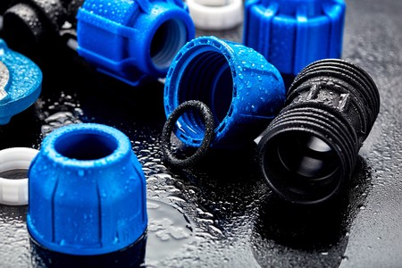 Set plumbing and tools on a green background.