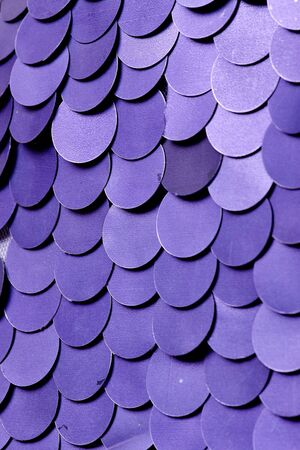 Fabric with sequins and sequins of bright colors. Fashion glitter fabric, sequins. can be used as backgroundの写真素材