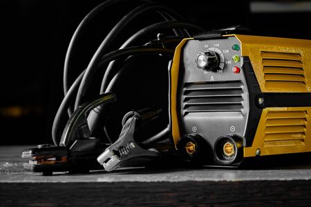 Inverter welding machine and terminals on a dark background waiting for their welder to start workingの写真素材