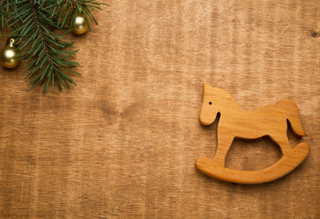 Classic homemade wooden rocking and christmas fir tree on wooden backgroundの写真素材