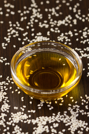 Sesame seeds  oil and sesame seeds on wooden tableの写真素材