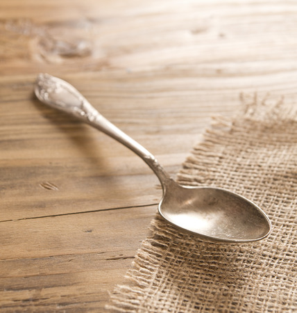 Vintage spoon on rustic wooden tableの写真素材