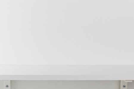 Empty white wooden shelf on white wood wallの写真素材