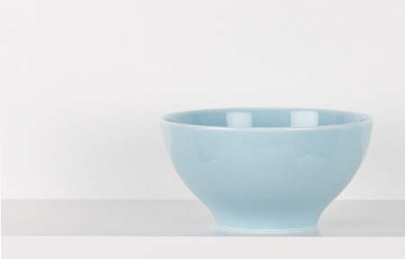 Blue bowl on white wooden shelfの写真素材