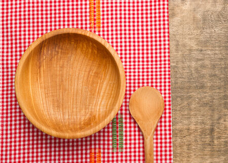 Wooden bowl and wooden spoon on rustic wooden tableの写真素材