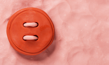 Red plasticine buttonの写真素材