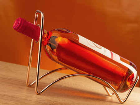 Rose wine bottle  on a metal wine rackの写真素材