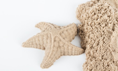 Sand starfish and sea sand on white backgroundの写真素材