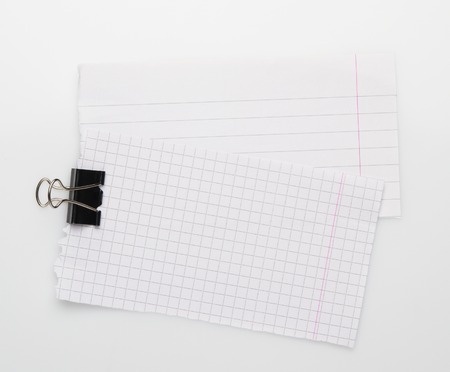 Note papers and paperclip on white