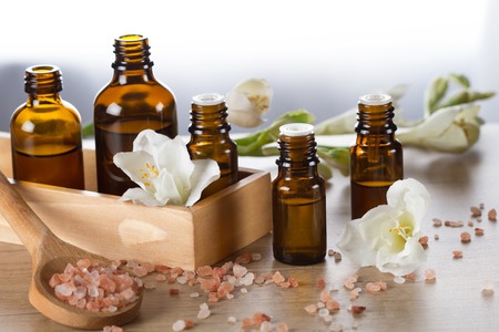 Essential oils for aromatherapy,himalayan salt, flowersの写真素材