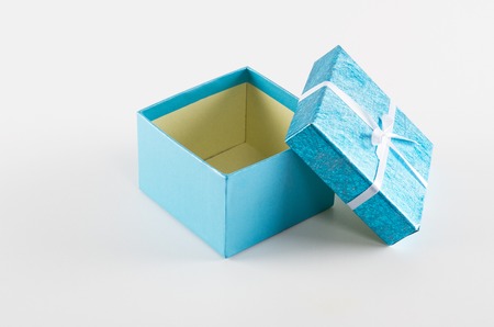 Empty blue gift box with ribbon on whiteの写真素材
