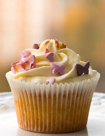 Handmade Cake with cream, hearts and stars. White plate with a pattern. Blurring background.の写真素材