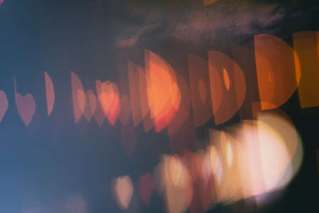 Bokeh in the form of heart on a black and blue background. Gradiebt.