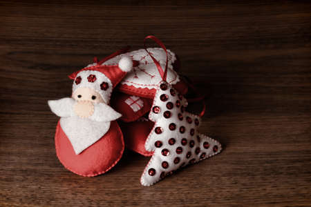 Santa claus, bear, rabbit, house, heart, and a bell. Handmade decorations.の写真素材