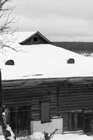 Vintage wooden house in the winter forest. Russian old wooden barn.の写真素材
