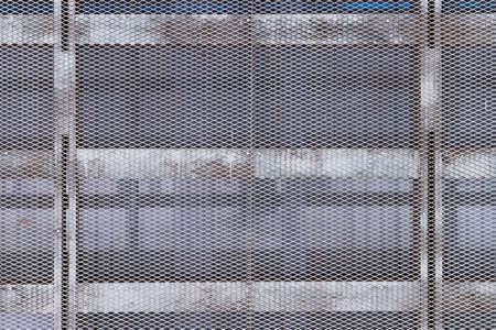 Metal mesh. Wall of metal mesh. Metal structure of the bars and mesh. Metal grid.の写真素材