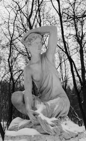 Moscow, Jan, 2017. Neskuchniy Garden. Gorky park. Sculpture of a girl in winter park covered with snow.の写真素材
