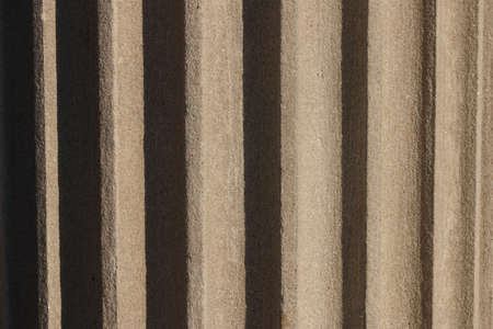 Fragment of the column with flutes. Bright sun reveals details. Monuments with pillars. Classic...
