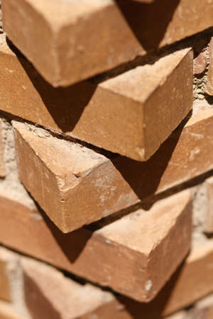 Corner of the brick wall. Red bricks. Brickwork. Rows of bricks.の写真素材