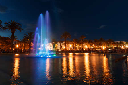 Colorful water fountain. Fountain with night lightsの写真素材