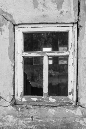 Broken window in the old house. Black and white photography.の写真素材