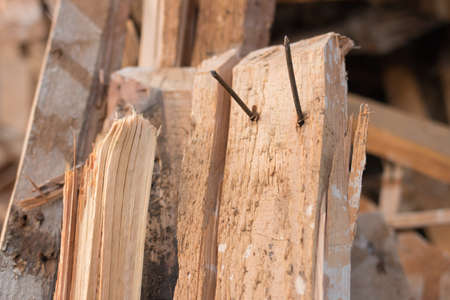Pile of planks after renovation of building. Heap of broken boards with nails. Old boards. Repair of the building. Construction garbageの写真素材