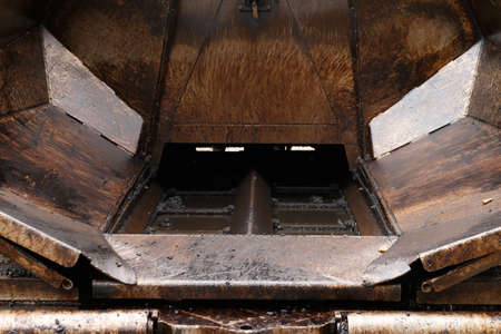 Detail of the mechanism. Asphalt paver machine. Dirty metal mechanism.