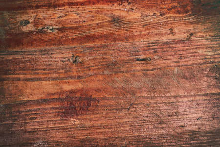 Grunge background of old red wooden plank. Horizontal stripes. Old wood texture with a shabby red paint front. Shabby wooden background.の写真素材