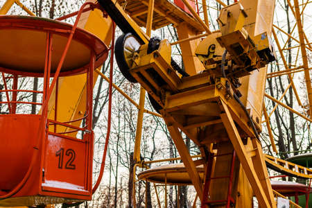 Colorful Ferris wheel in the autumn park. Fragment of the Ferris wheel. Bright metal structures of the attraction. Russia. Amusement park in autumn.の写真素材