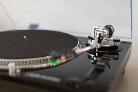 Vinyl record player. Details of the turntable player. Musical equipment with shallow depth of field.の写真素材