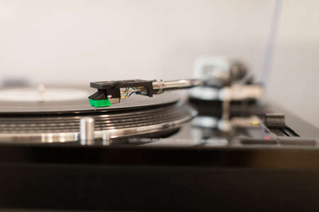 Vinyl record player. Details of the turntable player. Musical equipment with shallow depth of field.