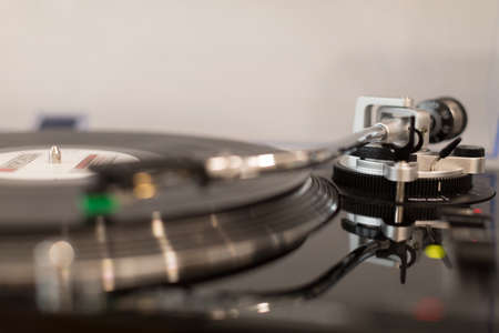 Vinyl record player. Details of the turntable player. Musical equipment with shallow depth of field.の写真素材