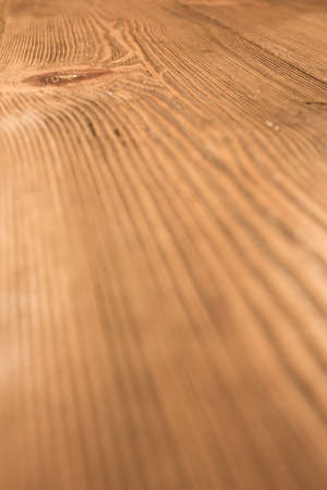 Rough texture of a board with knot. Texture of a board with a bough. Perspective view with shallow depth of field.の写真素材