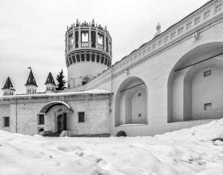 Novodevichiy convent. Winter day in Moscow, Russia. The chamber of the princess Sophia. Nadprudnaya tower. Wall of the Novodevichy Convent. Black and white photograph of ancient Russian religious architecture.の写真素材