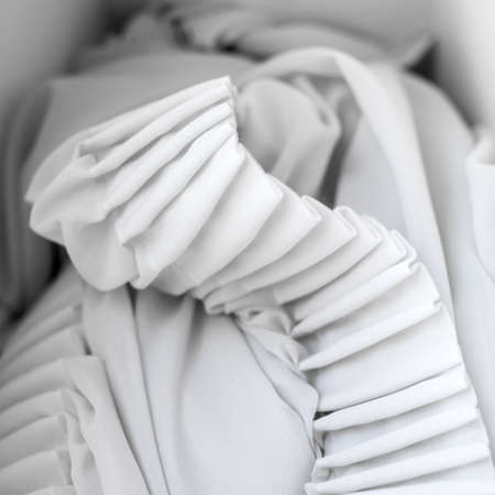 The folds of white chiffon. Abstract composition. Waves of fabric. Pattern from the waves of the curtain. Abstract soft chiffon texture backgroundの写真素材