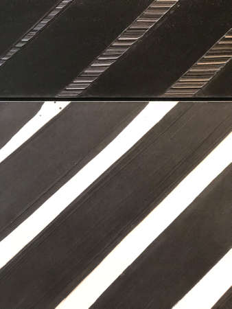 Black and white striped diagonal texture. Black and white stripes closeup. Background texture.