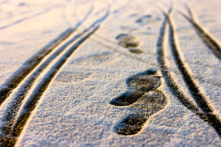 Creative abstract background from the set of traces of human foot prints and the wheels of baby...