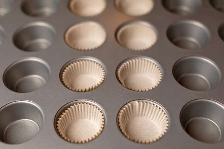 Metal mold for making muffins. Kitchen equipment for cupcakes. Preparation for the holiday.の写真素材